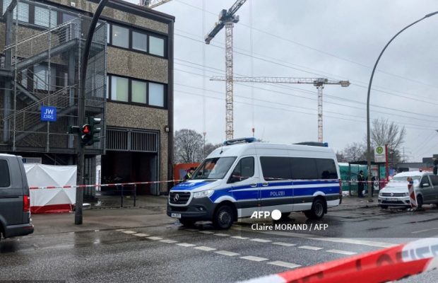 A police car stands at the site where several people have been killed in a church in a shooting the night before in Hamburg, northern Germany on March 10, 2023. A shooting at a Jehovah's Witness centre in the German city of Hamburg has left eight people dead, including the suspected gunman, police said on March 10, 2023. (Photo by Claire MORAND / AFP)